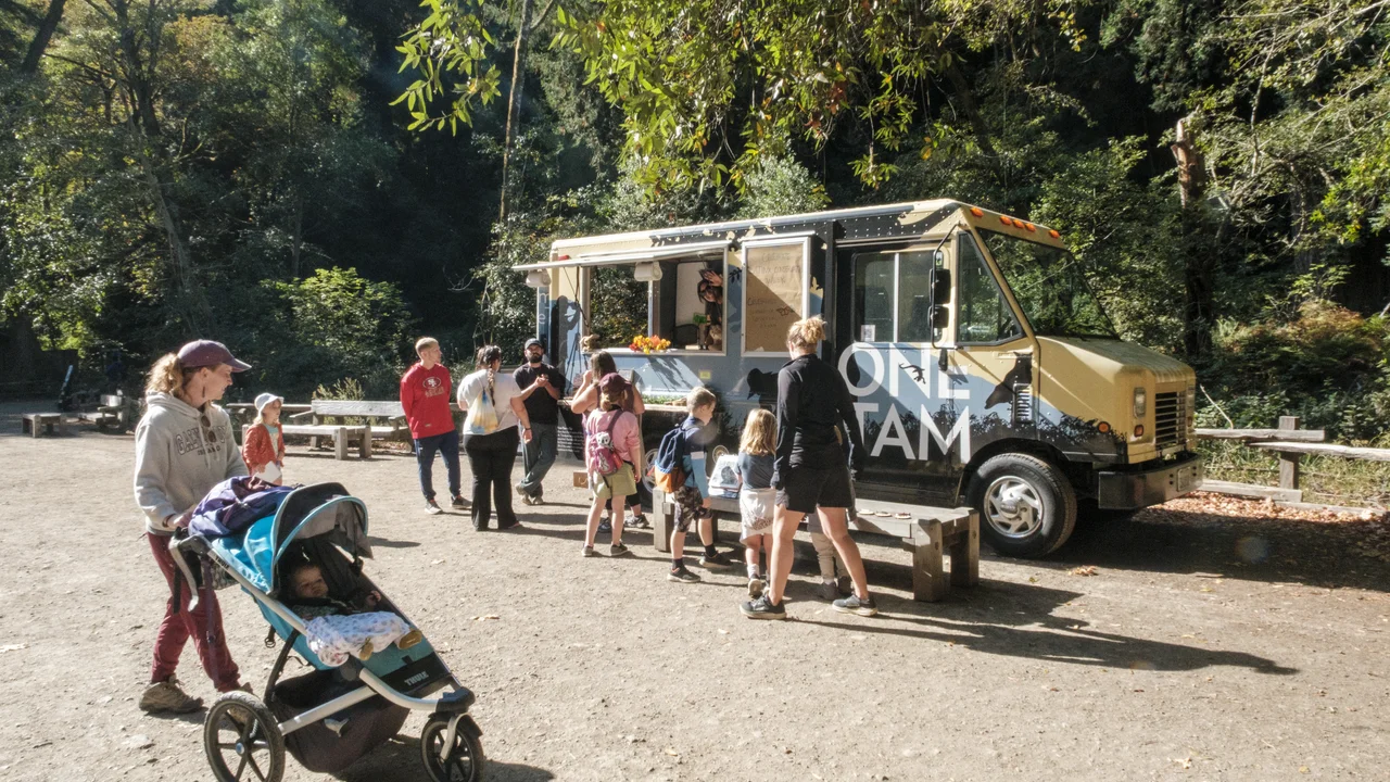 Visitors Interacting with Tam Van at Muir Woods National Monument 