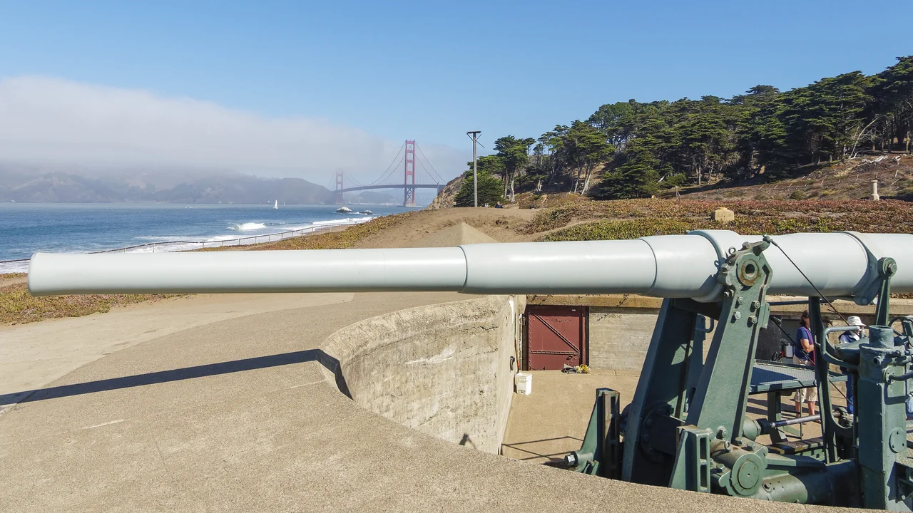 View of historic Battery Chamberlin gun at Baker Beach with the Golden Gate Bridge in the background.