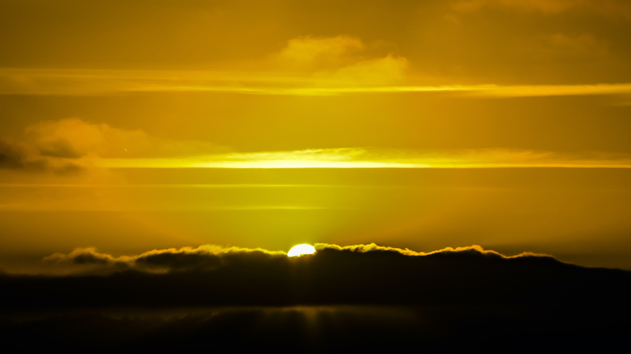 Sun breaking through storm clouds