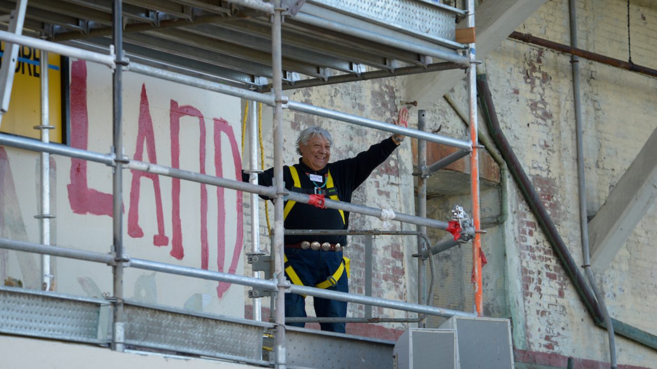 ALCA_20191120_RCW_0084_2x1.jpg Alcatraz occupier waves after painting political slogan during 50th anniversary celebration