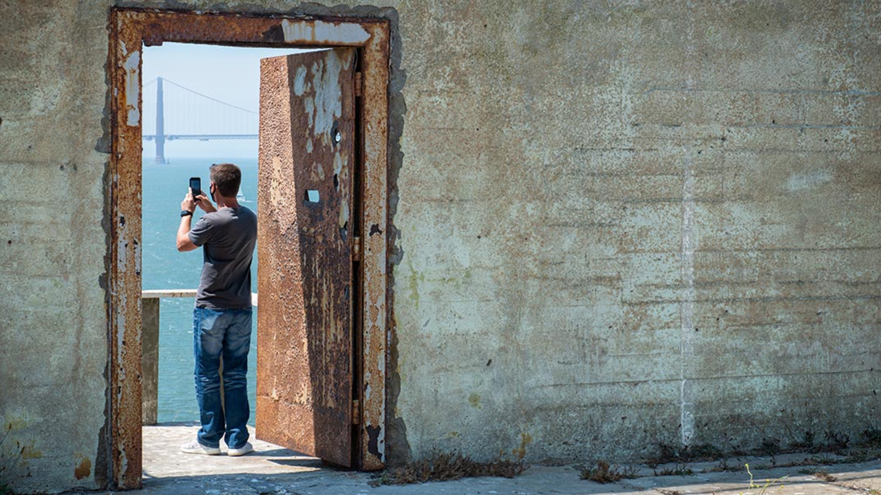 A visitor takes a photo on Alcatraz Island.