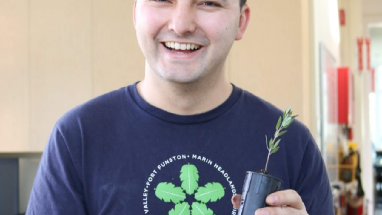 Brian Teng holding a potted manzanita