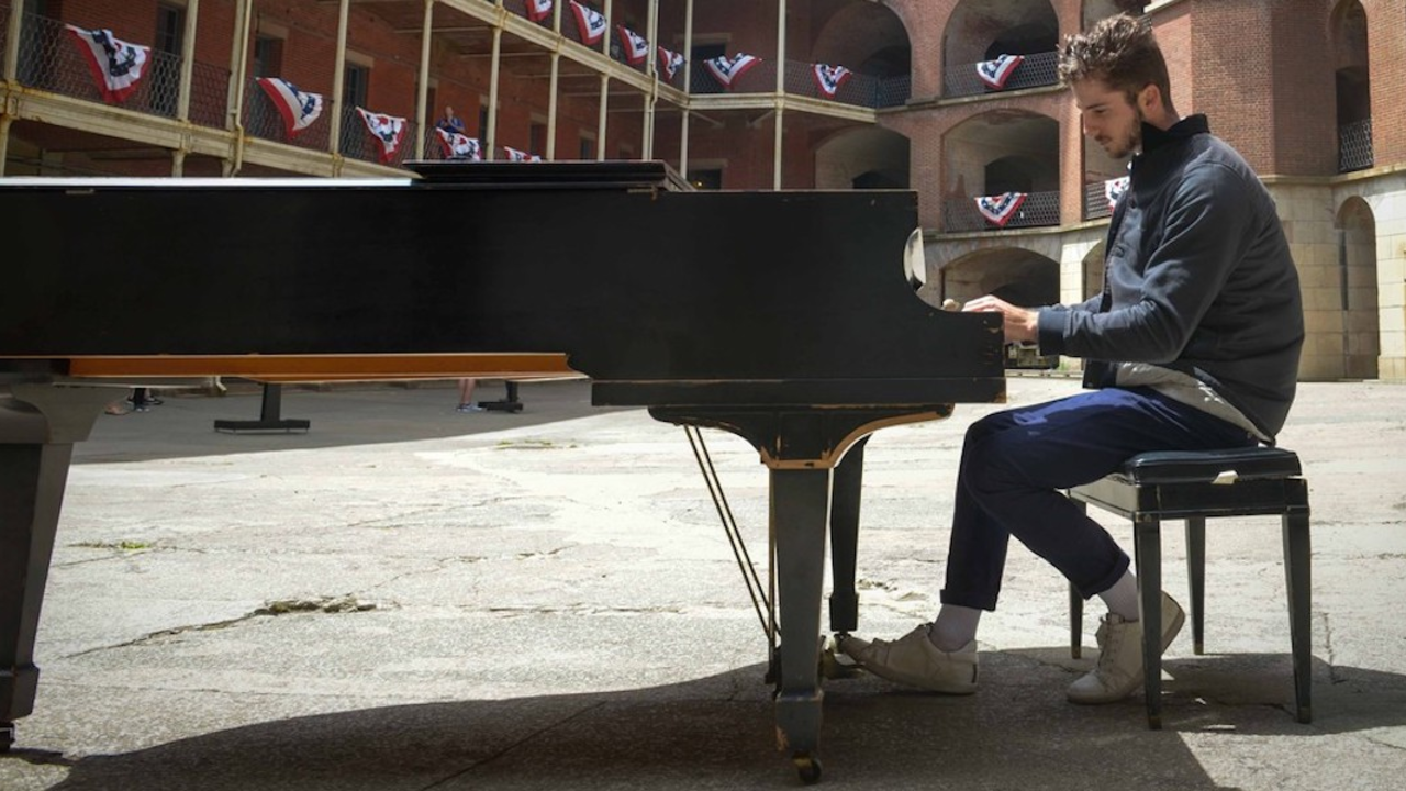 Man plays piano while at Fort Point National Historic Site