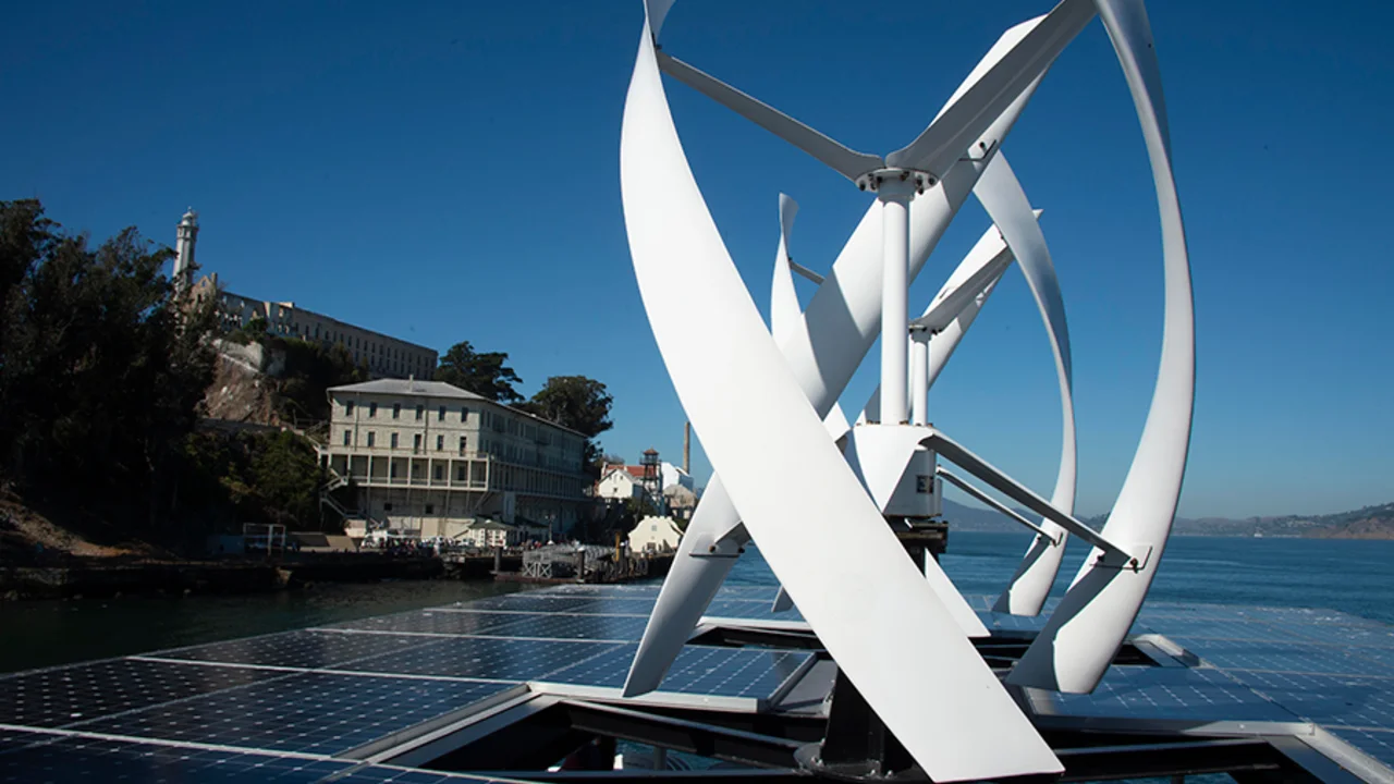View of wind turbines and solar panels from atop an Alcatraz cruises boat.