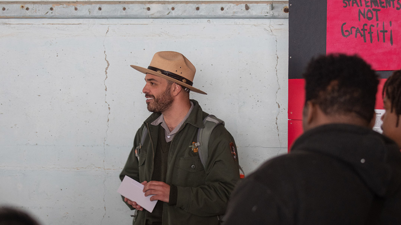A park ranger smiling during a program on Alcatraz Island.