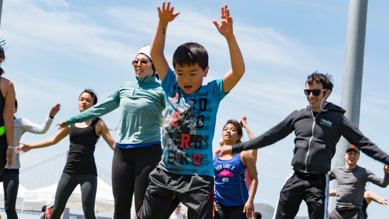 Kid jumping against blue sky