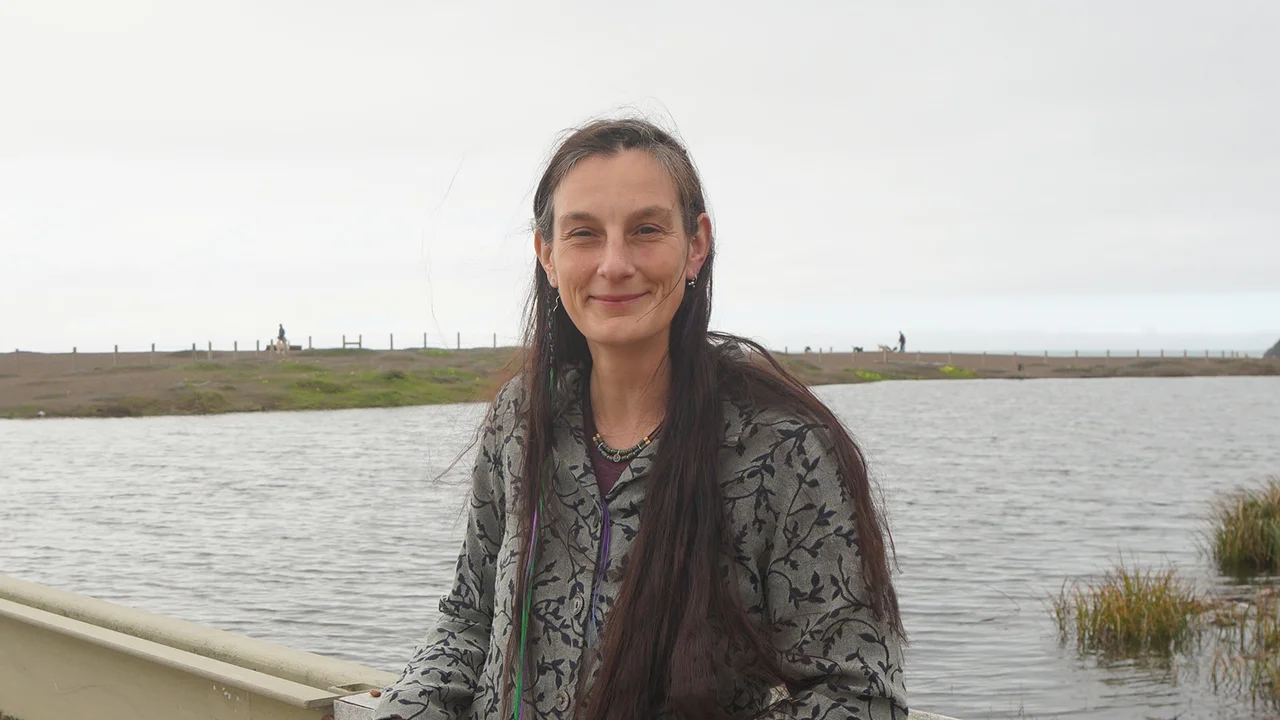 Portrait of Data manager Lizzy Edson smiling on the bridge by Rodeo Lagoon.