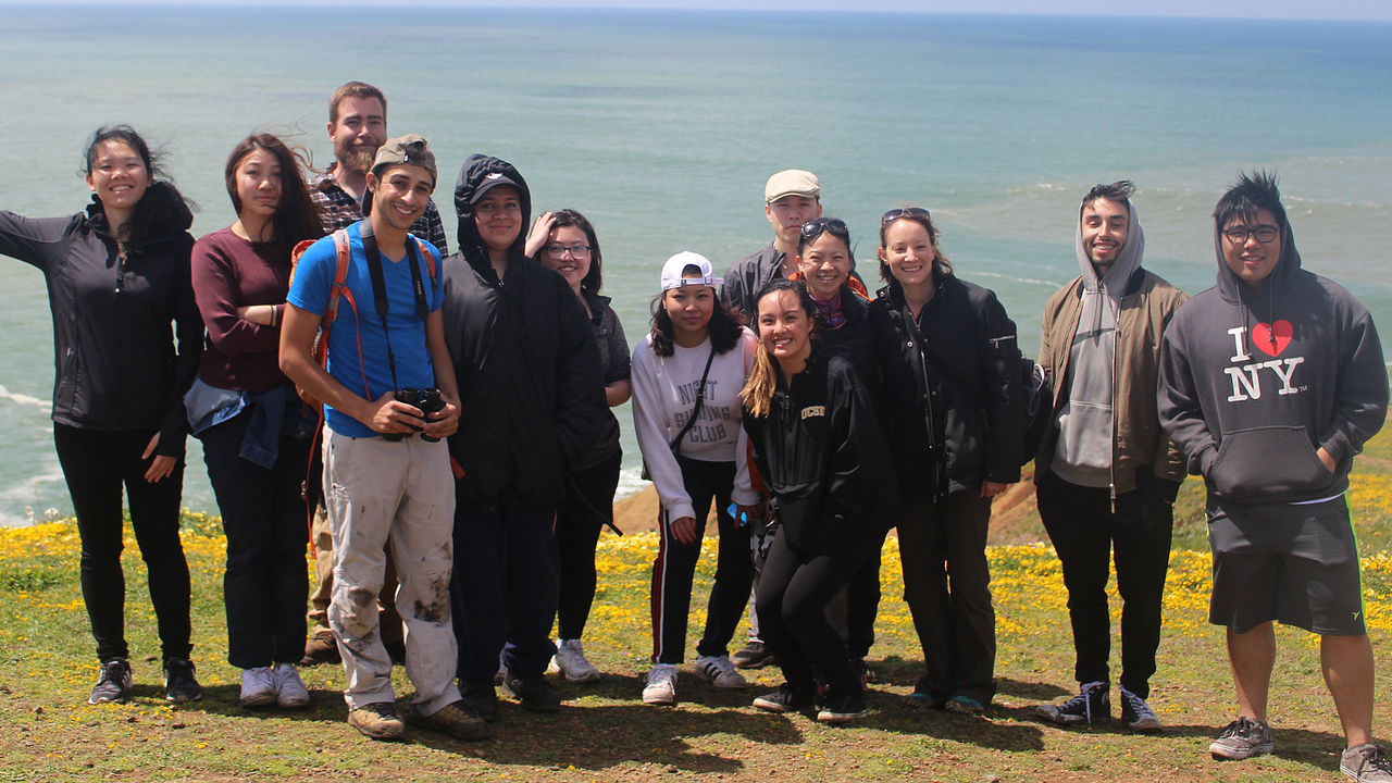 City College of San Francisco students enjoy the wildflowers and sweeping views at Mori Point at the end of a fun program weeding
