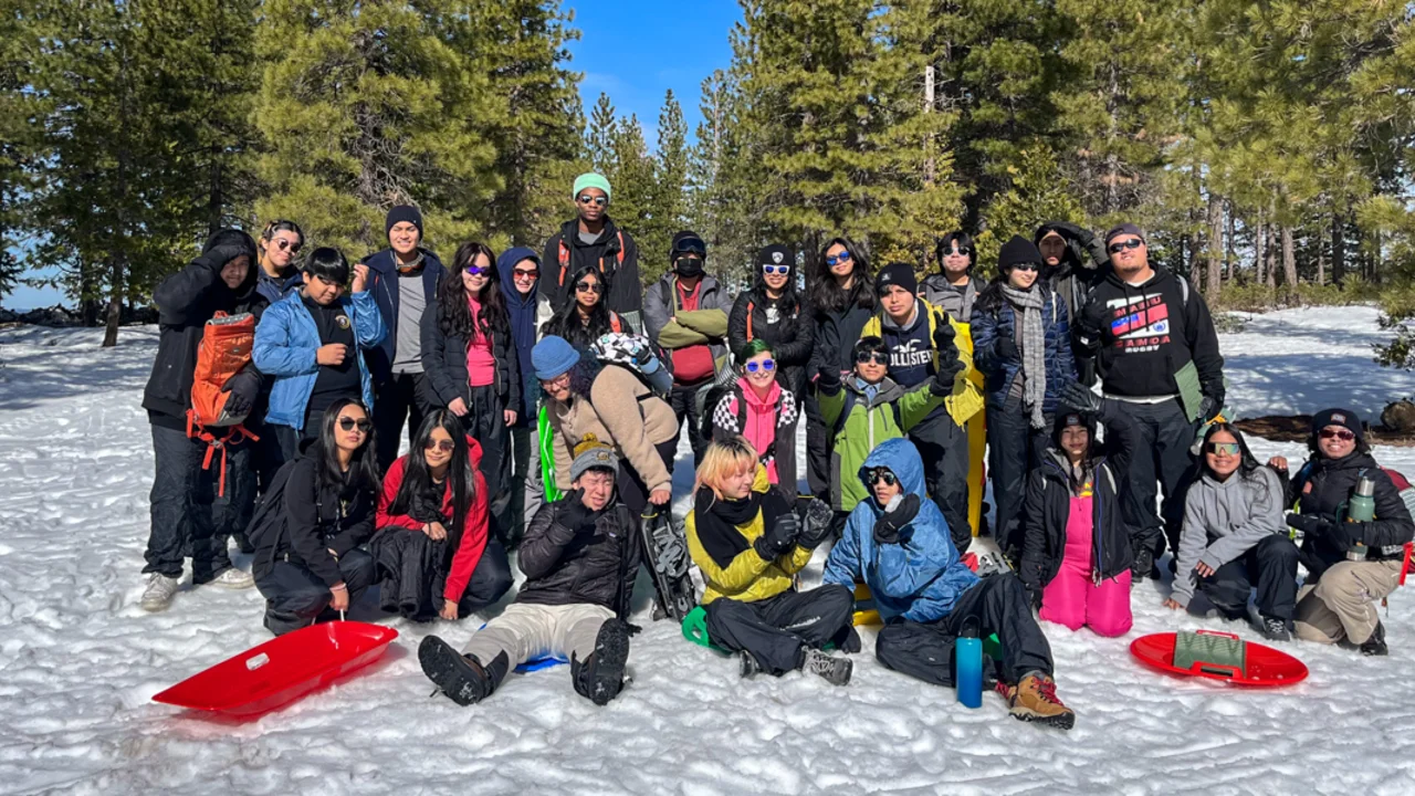Crissy Field Center IYEL youth participants pose for a group photo in the snow during their winter trip.