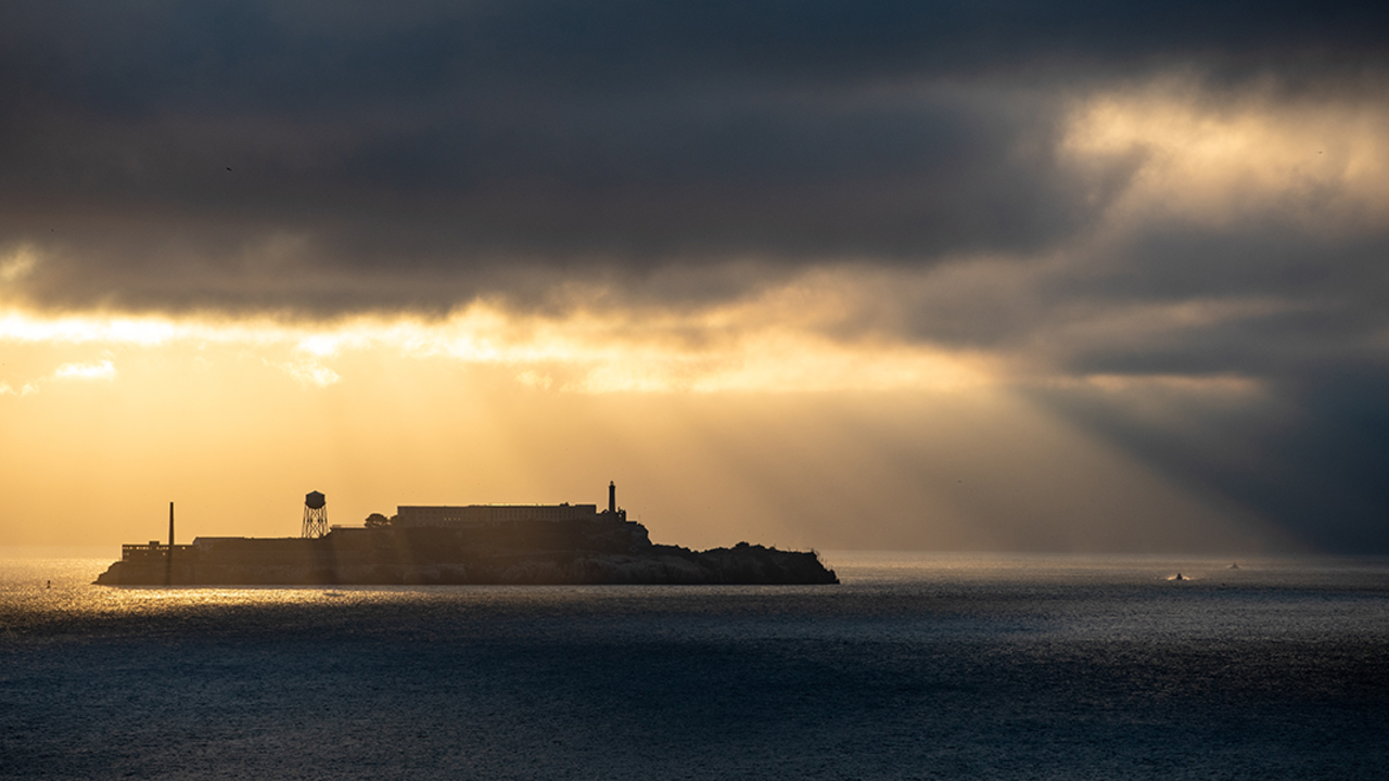 ALCA_20190709_PMM_0040_2x1.jpg Sunlight breaks through gloomy fog over Alcatraz Island