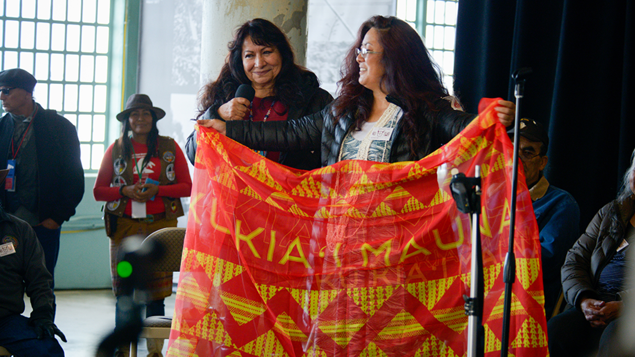 ALCA_20191120_RCW_0047.jpg two woman on stage with banner