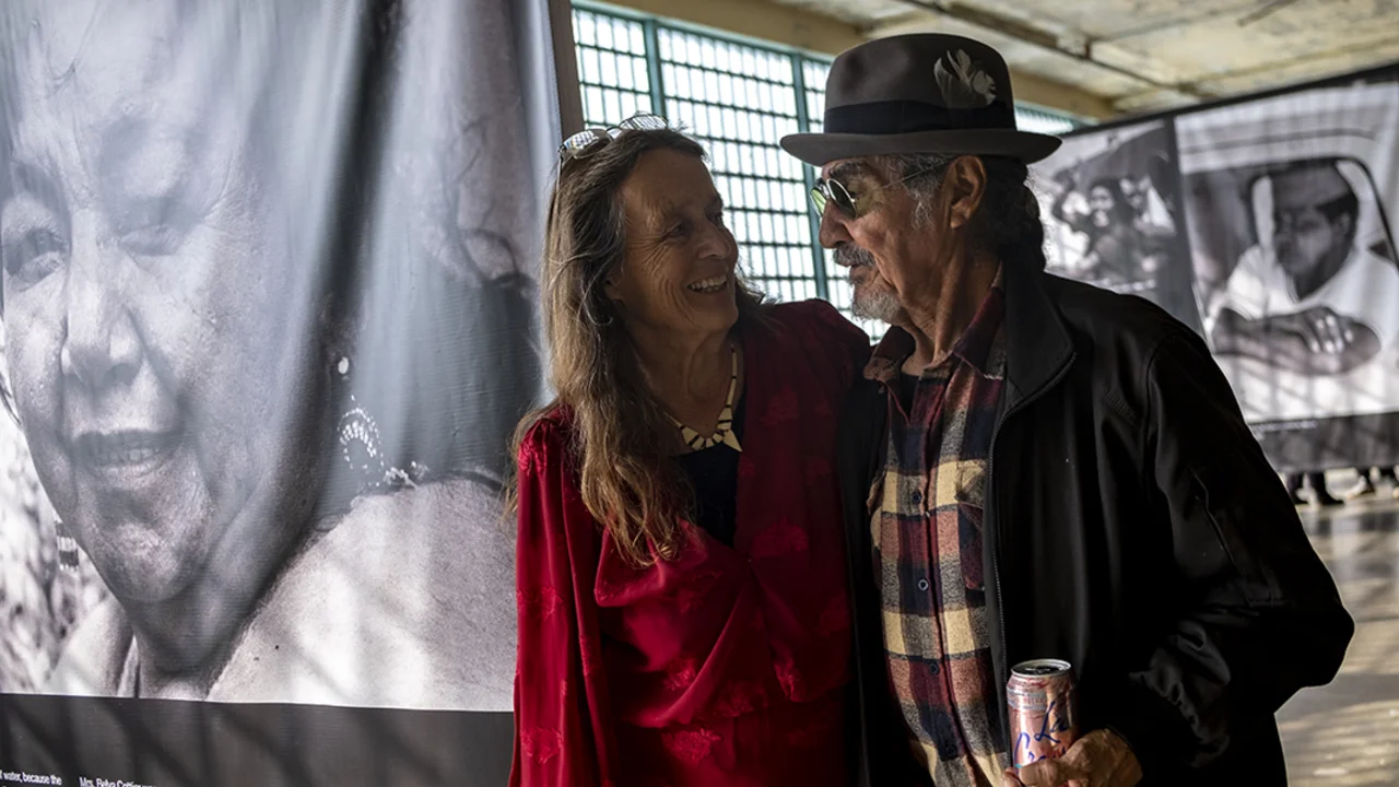 man and woman surrounded by black and white photos