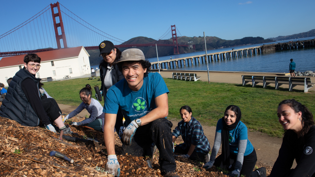 Conservancy Interns Working at Crissy Field Interns smile for a photo while doing park stewardship work at Crissy Field.