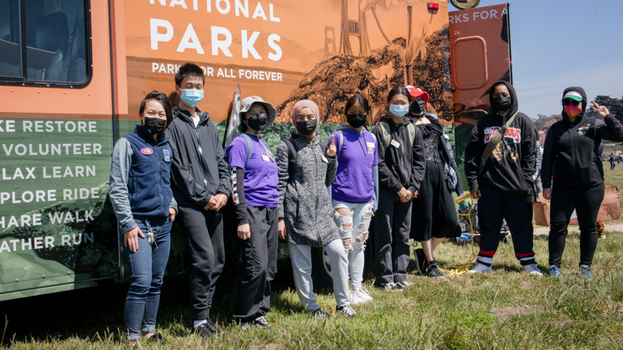 IYEL youth pose for a group photo by the Roving Ranger at Crissy Field.