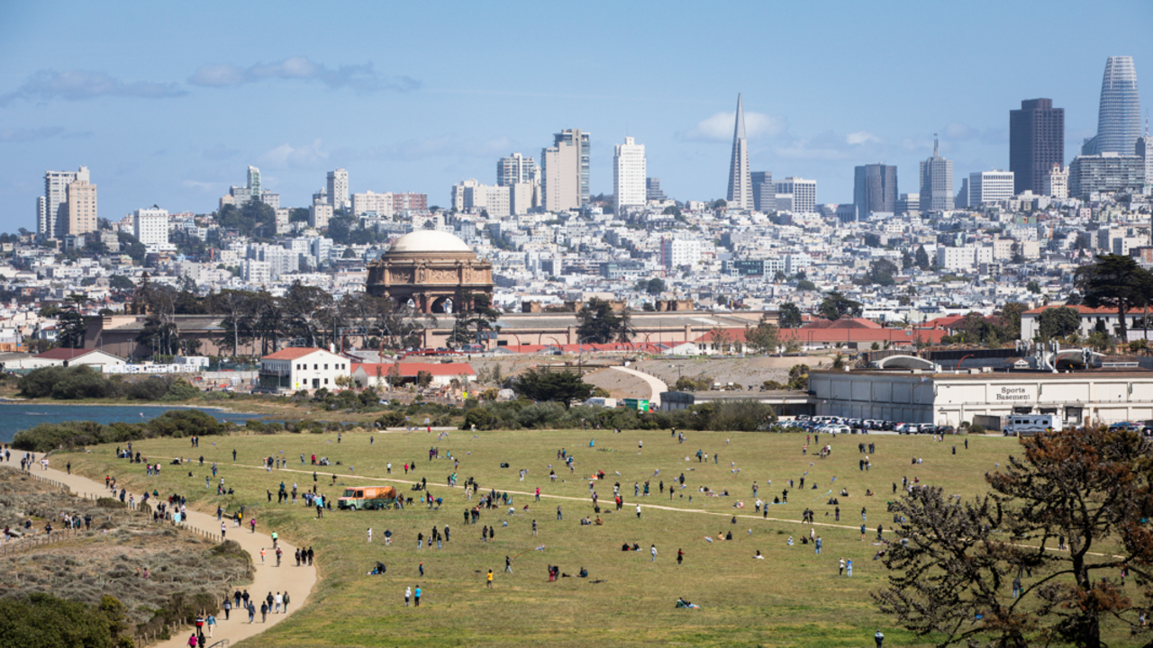 Park goers gathered at Crissy Airfield. A crowd is gathered at Crissy Airfield on a beautiful day in San Francisco