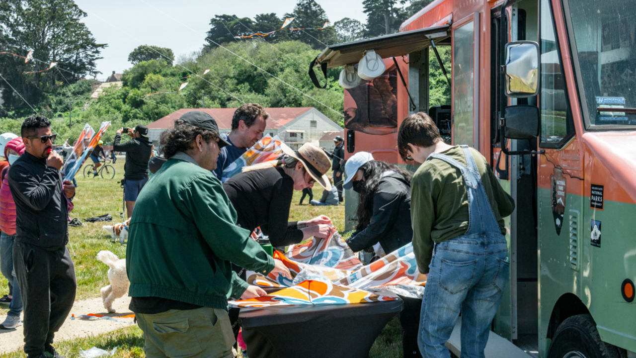 Park goers build their kites by the Roving Ranger at Crissy Field. Park goers build their kites by the Roving Ranger at Crissy Field