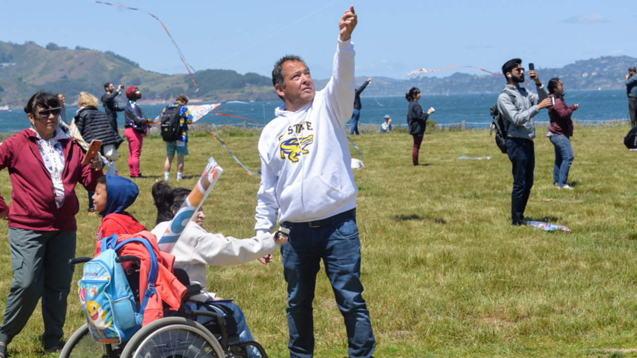 Families enjoying kite flying at Crissy Field A family enjoys flying a kite at Crissy Field.