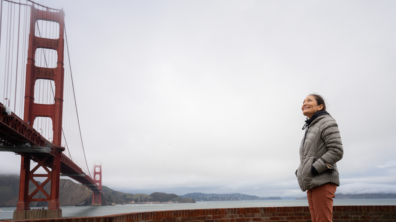 Secretary of the Interior Deb Haaland gazing at the Golden Gate Bridge