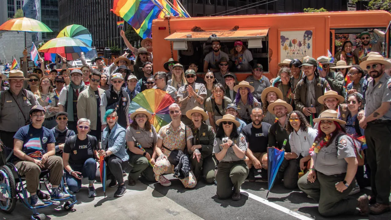 Staff from the Parks Conservancy, National Park Service and the Presidio Trust pose for a group photo during the 2023 Pride Parade.