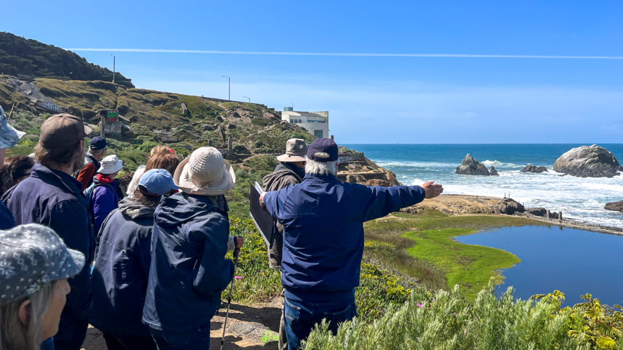 Members tour at Lands End Parks Conservancy members group looks out to the ocean from Lands End