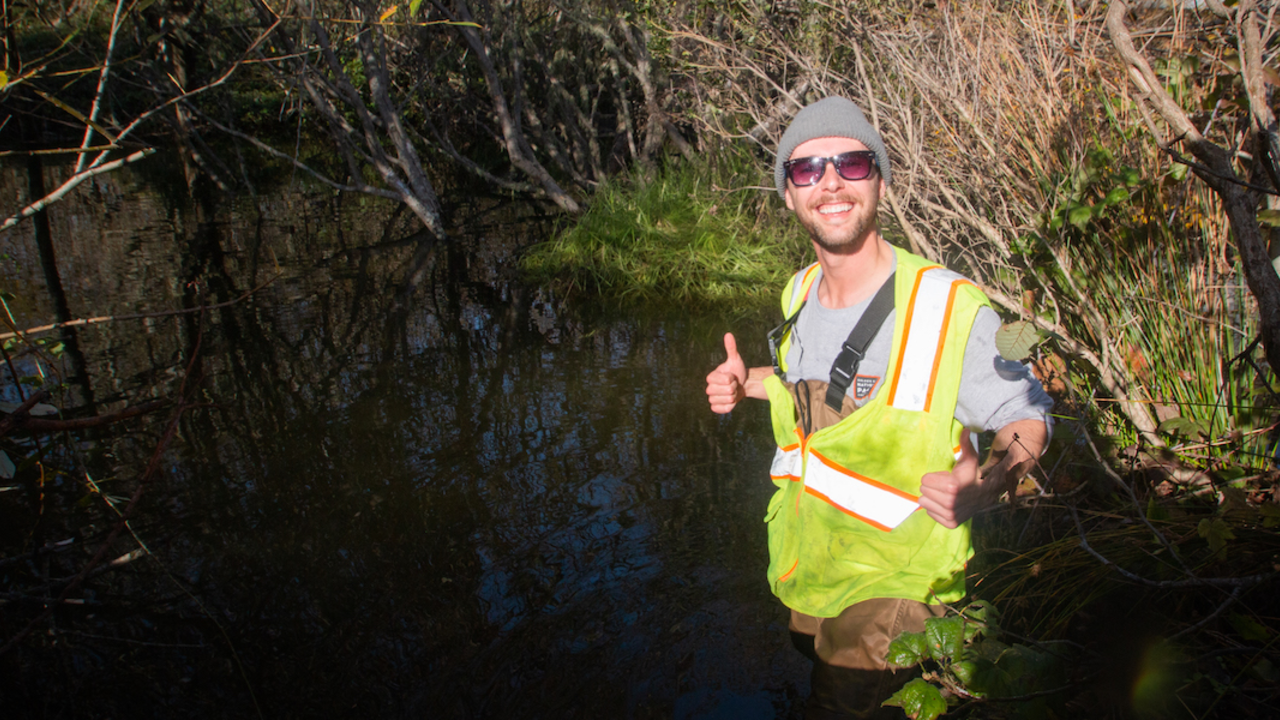MUBE_20181218_RCW_32_2x1.jpg Person standing in Redwood Creek at Muir Beach with his thumbs up during a re-release of coho salmon.