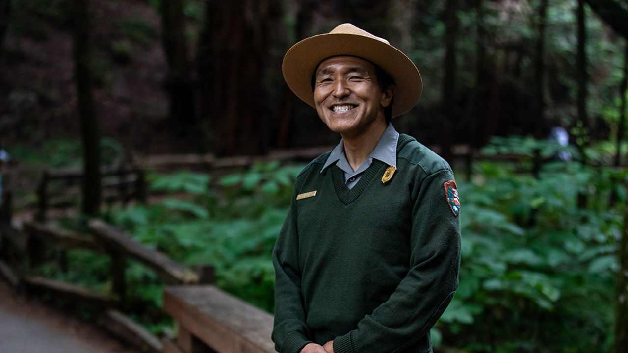 MUWO_20190614_PMM_0119_2x1.jpg National Park Service ranger smiles in Muir Woods