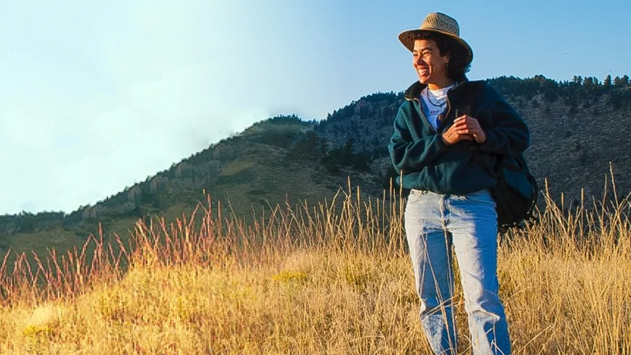 Dr. Nina Roberts stands in a field with Mount Tamalpais in the background.