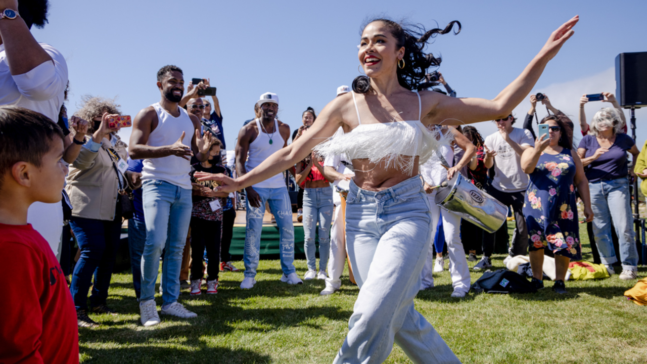 A dancer dances amongst the crowd at the Presidio Tunnel Tops. A dancer dances amongst the crowd at the Presidio Tunnel Tops.