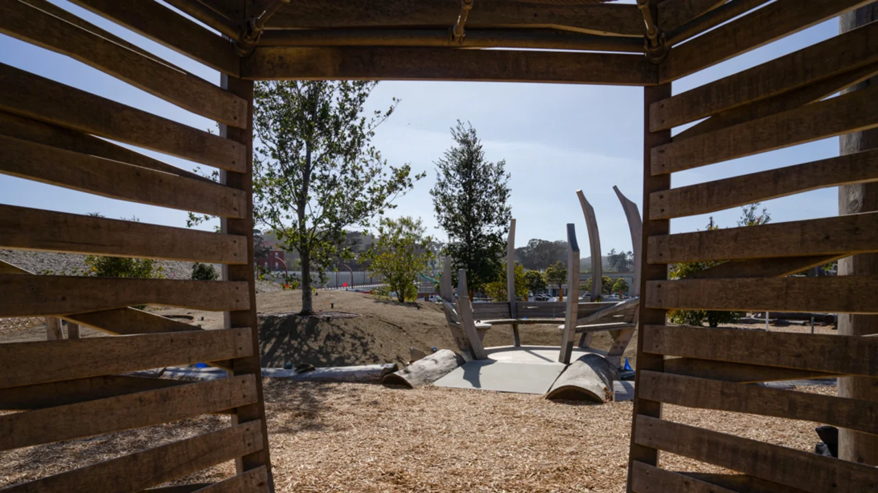 A view looking out from inside of one of the wooden play structures at the Outpost at Presidio Tunnel Tops.