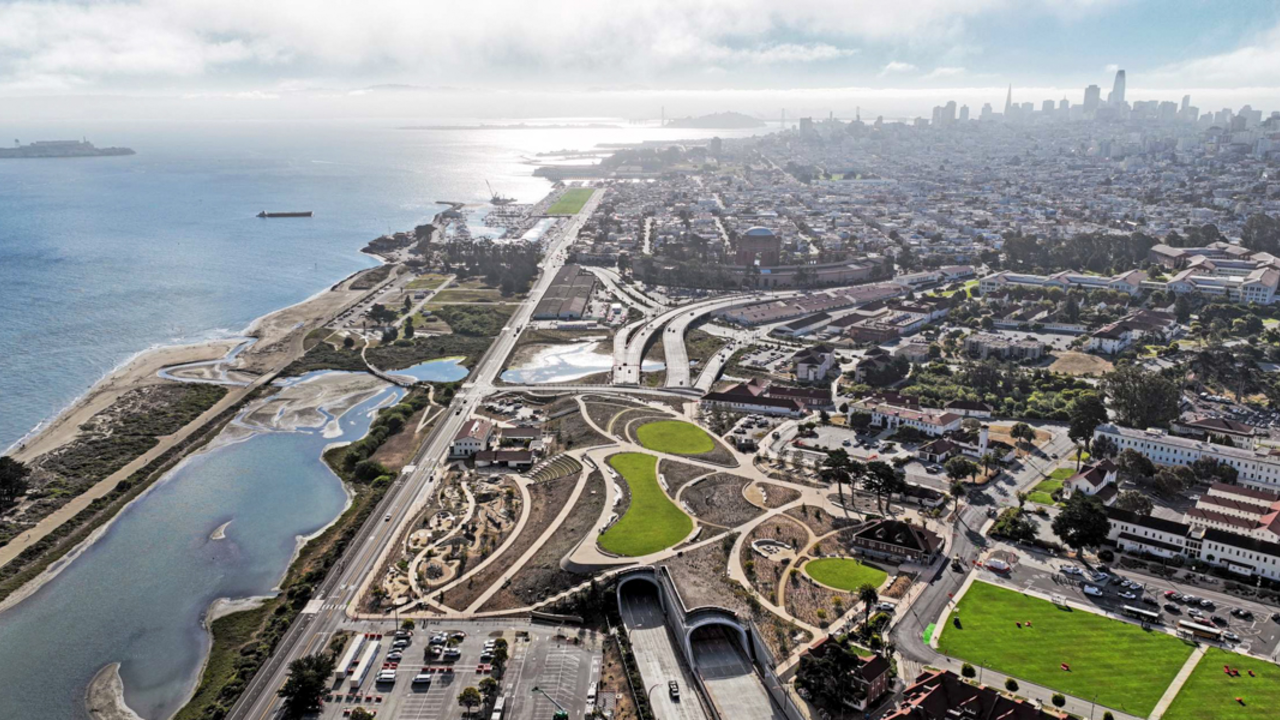 Aerial view of the Presidio Tunnel Tops and San Francisco on a sunny day.