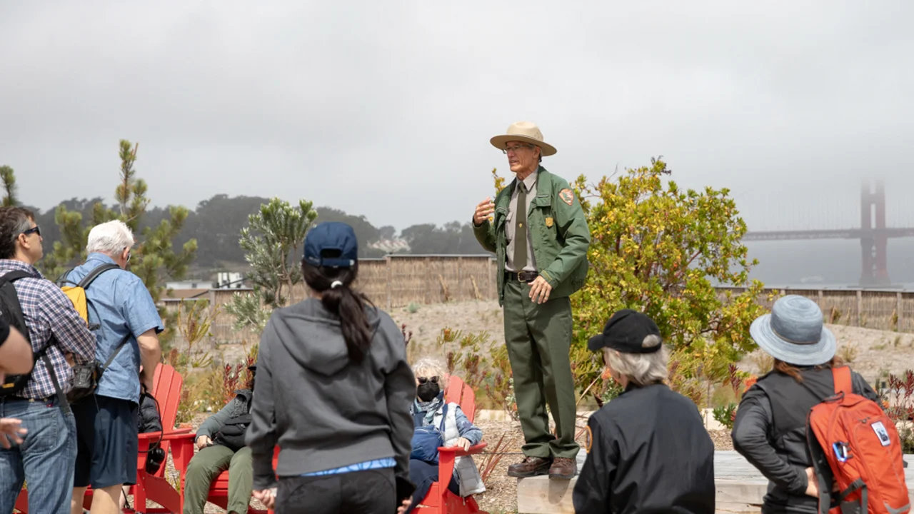 A Golden Gate National Recreation Area Park Ranger leads a discussion at Presidio Tunnel Tops Campfire Circle.