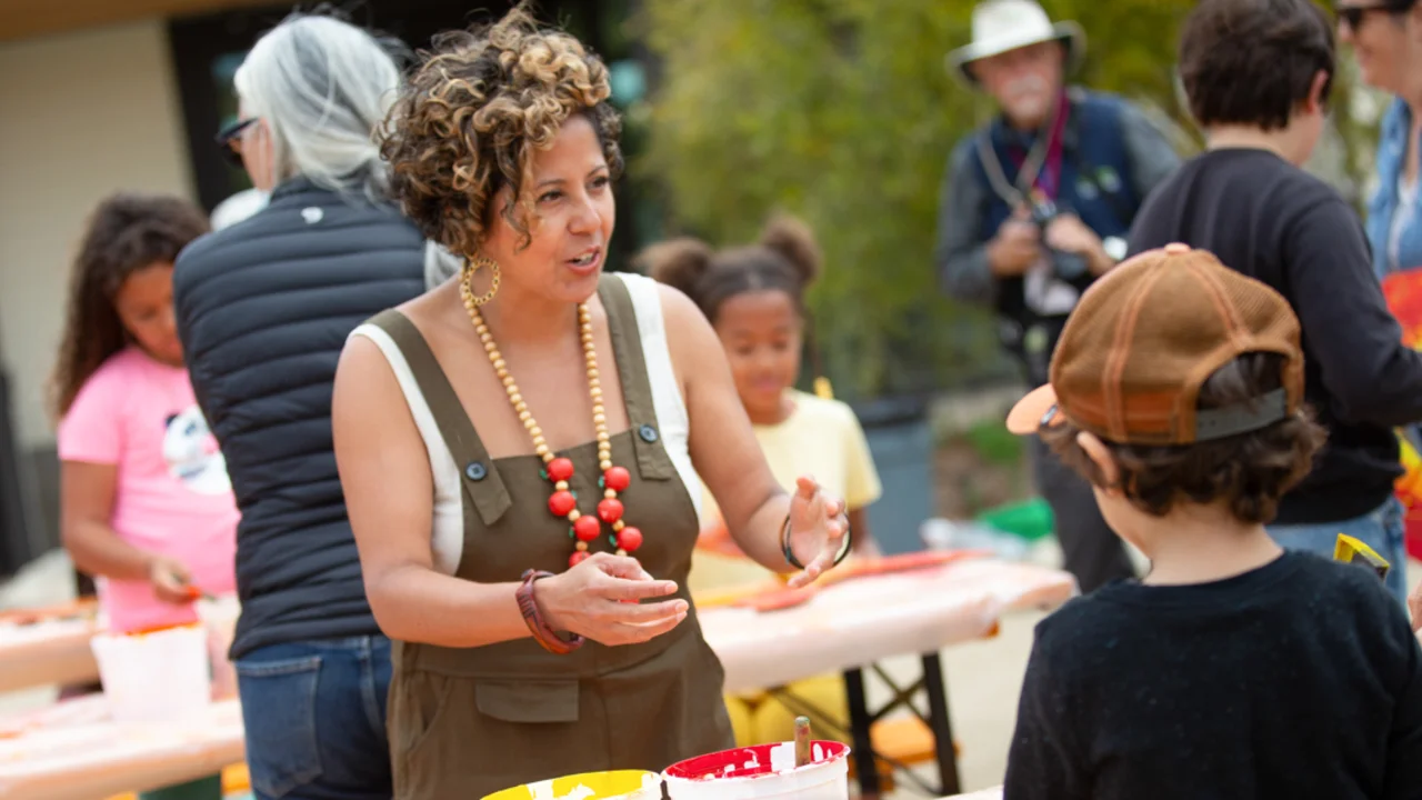 Presidio Activators Council Favianna Rodriguez guides children in art projects.