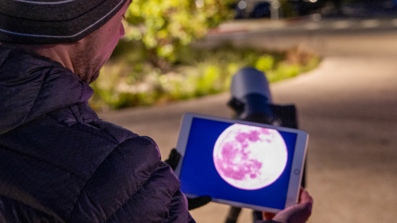 Viewing the pink full moon through an ipad, seen through a Unistellar telescope.