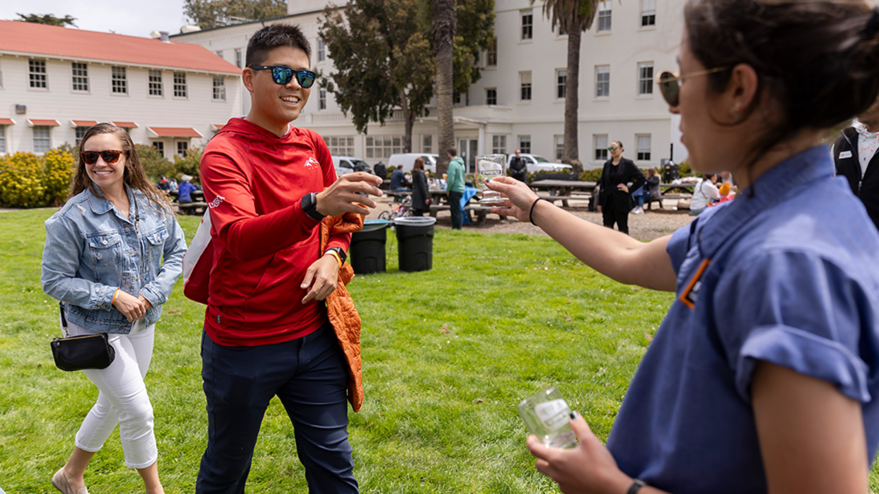 Parks Conservancy staff hand out souvenir beer tasting glasses at Parks4All: Brewfest, a beer festival and fundraiser, on Saturday, July 29th, 2023 in the Presidio of San Francisco. 