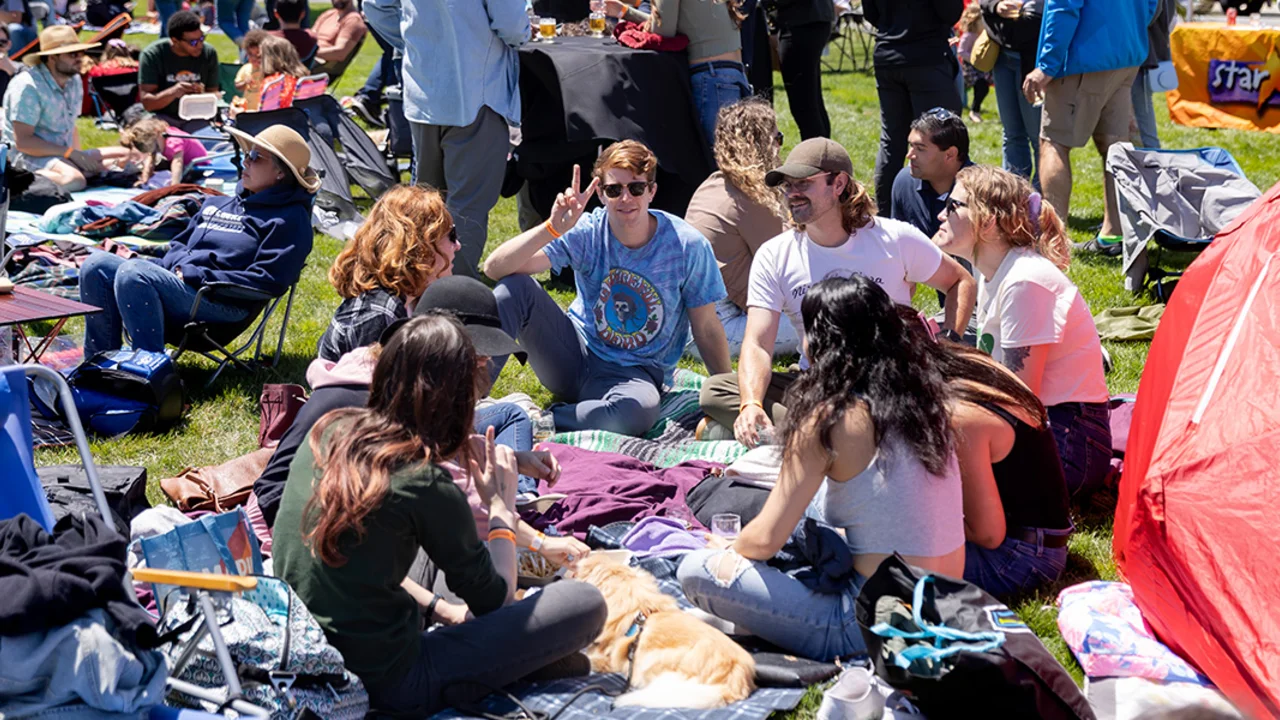 A group of friends sitting on a picnic blanket at Parks4All: Brewfest, a beer festival and fundraiser, on Saturday, July 29th, 2023 in the Presidio of San Francisco.