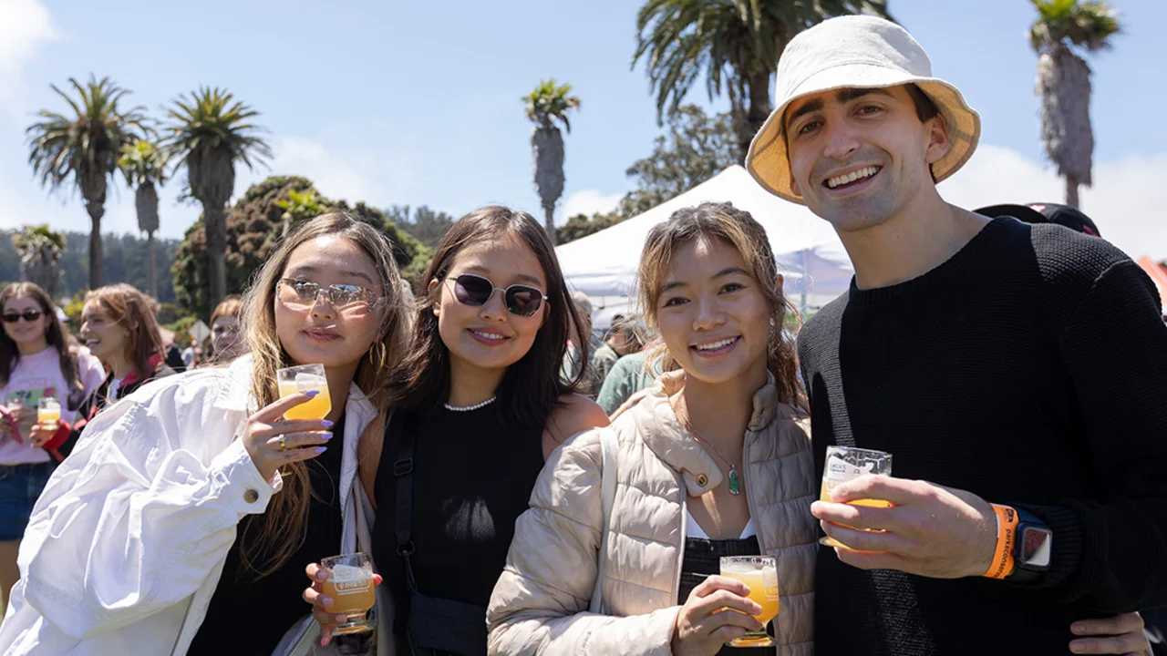 A group of friends pose with tasting glasses at Parks4All: Brewfest, a beer festival and fundraiser, on Saturday, July 29th, 2023 in the Presidio of San Francisco.