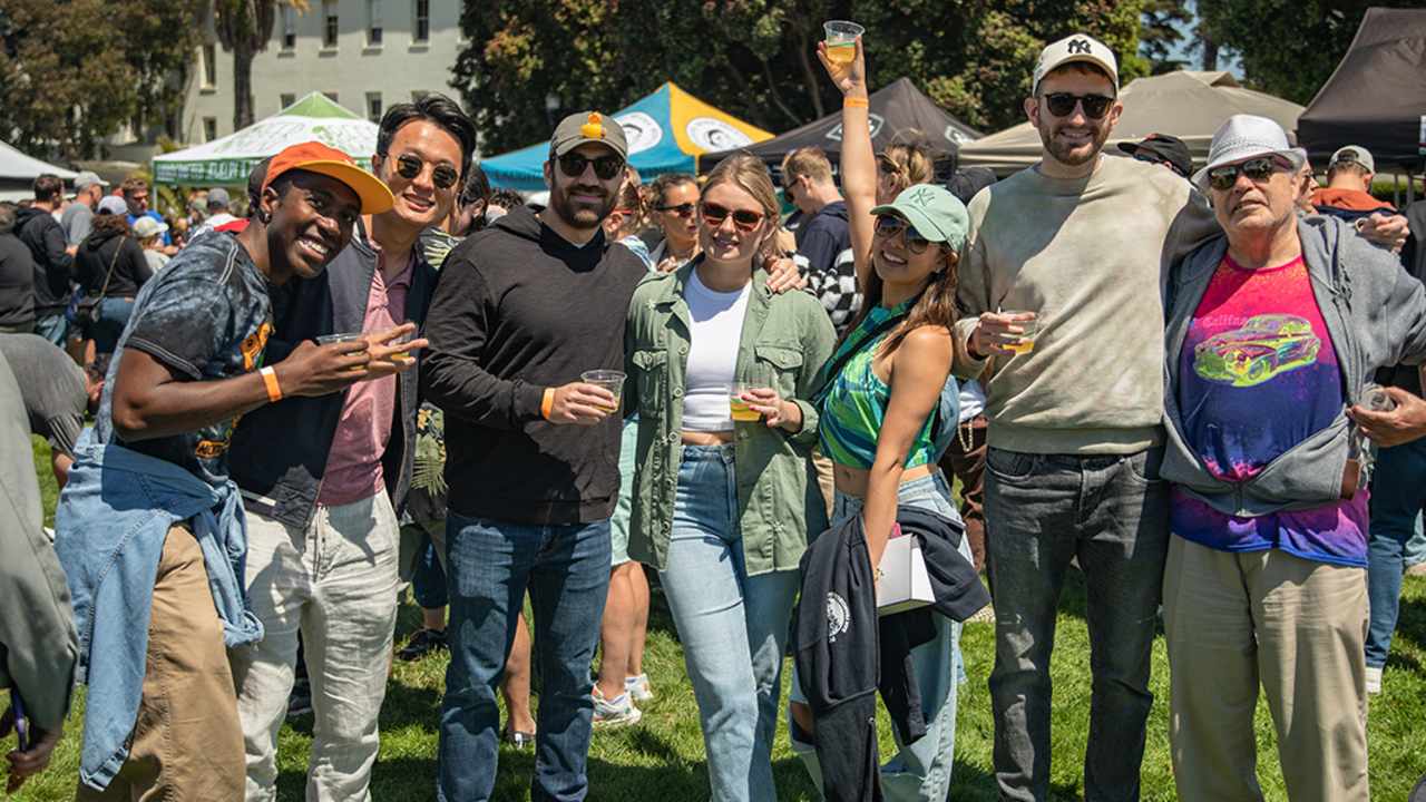 A group of friends line up for a photo at Parks4All: Brewfest, a beer festival and fundraiser, on Saturday, July 29th, 2023 in the Presidio of San Francisco.