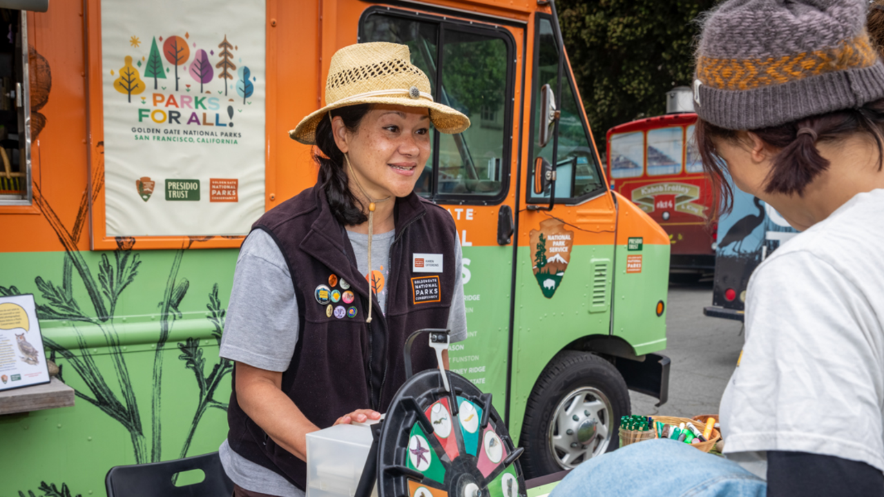 A Parks Conservnacy staff member engages with Brewfest attendees.