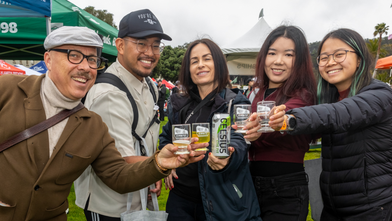 A group of people putting together their Parks4All: Brewfest glasses to cheers for the camera.