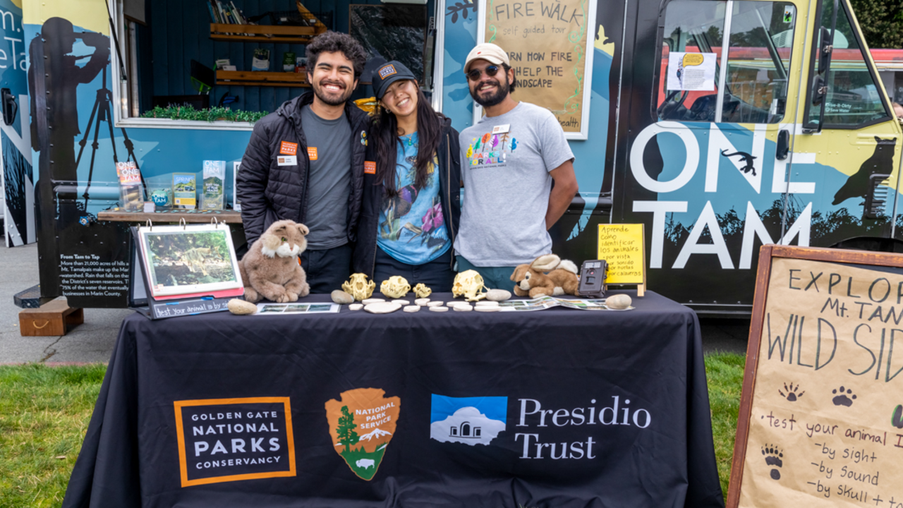 Smiling Parks Conservancy members pose for the photo in front of the One Tam Van.
