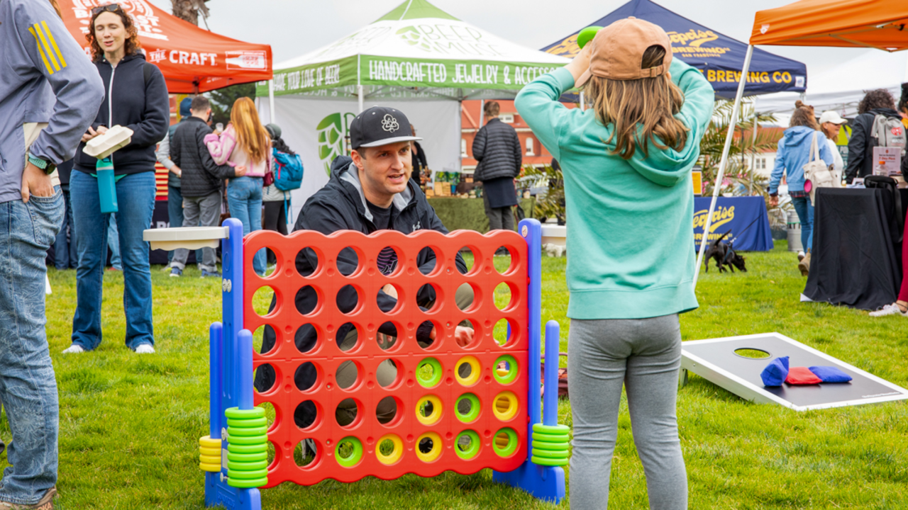 A parent and child playing lawn games at Parks4All: Brewfest in the Presidio