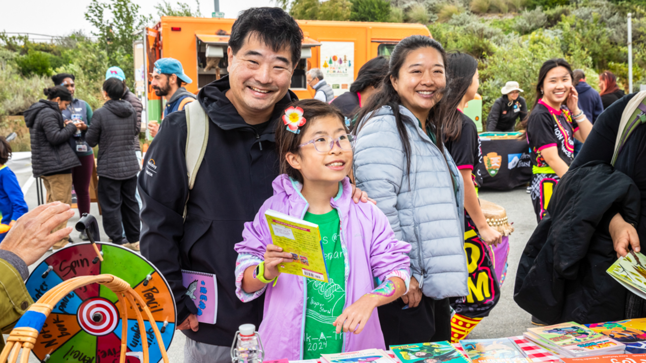 A smiling family enjoying activities at Access to Adventure day in the Presidio of San Francisco.