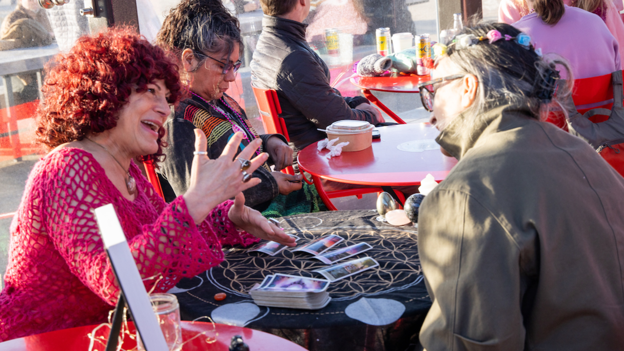 Tarot card reading at Pink Full Moon Party 2025.