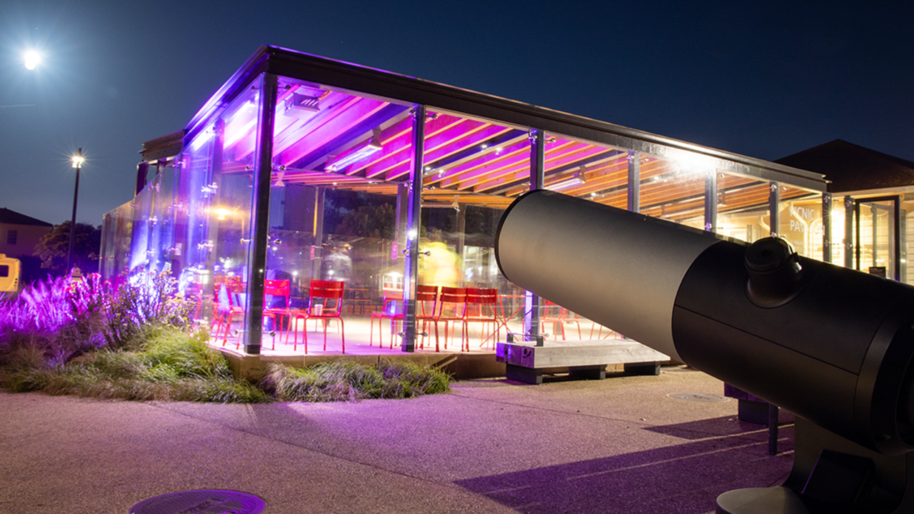 Telescope looks out at the moon at Pink Full Moon Party 2025.