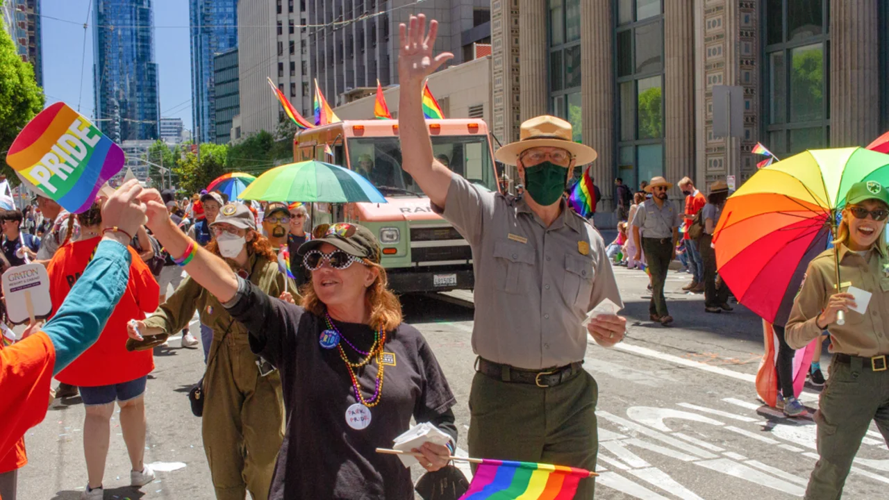 Conservancy, NPS, and Presidio Trust partners handing out stickers at the 2022 SF Pride parade.