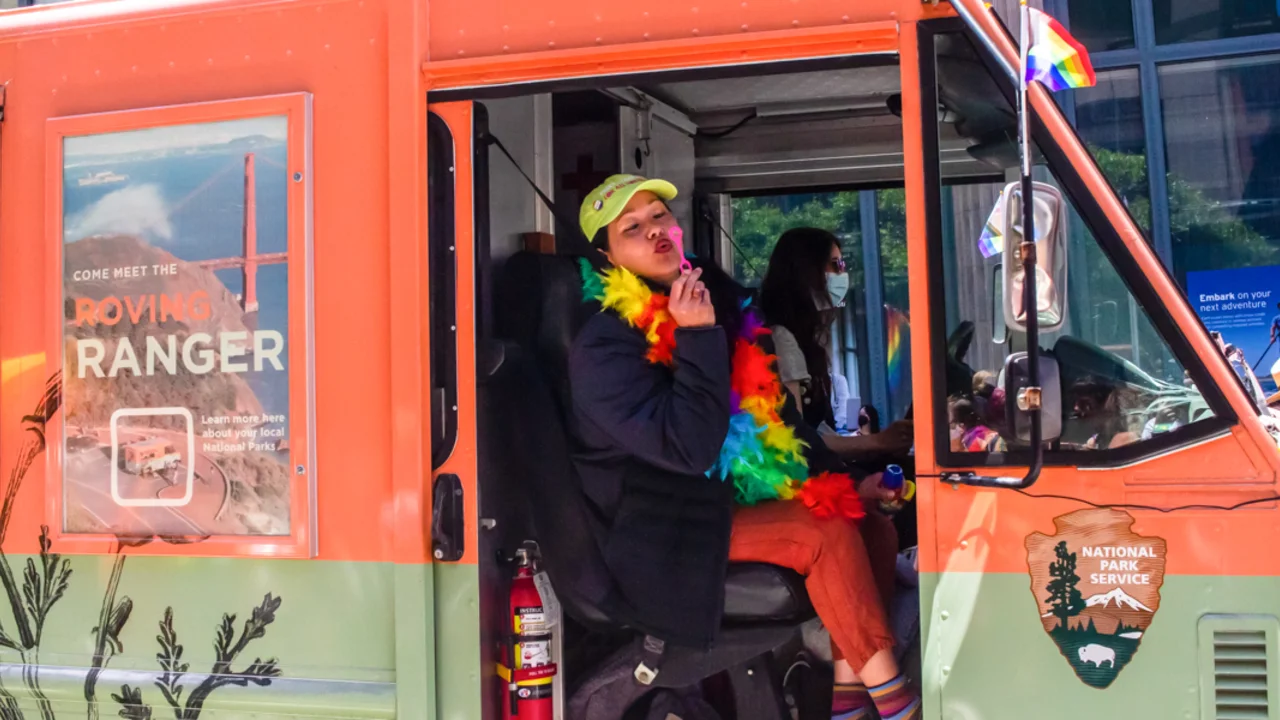 A Conservancy staff member blows bubbles from the Roving Ranger at the 2022 SF Pride parade.