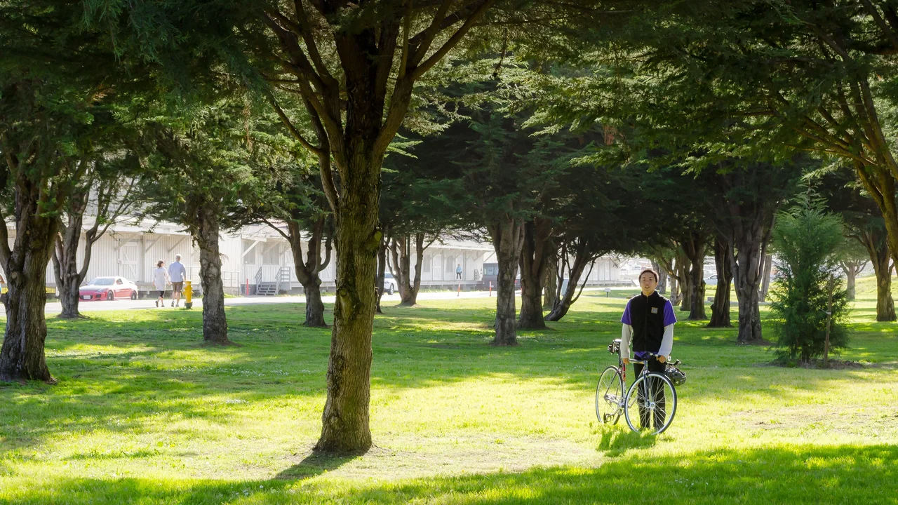 Cyclist rests by the trail through east Crissy Field