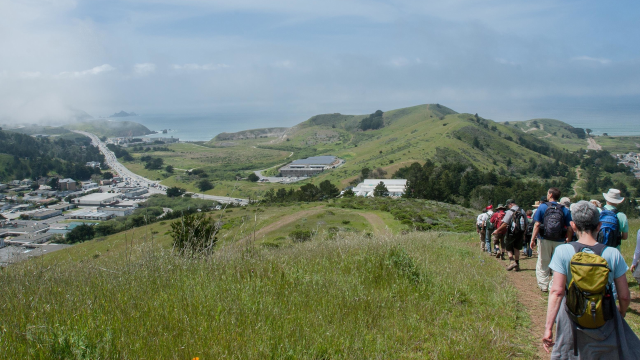 Hikers make their way down Sweeney Ridge