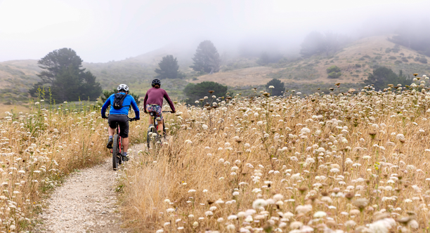 Two cyclists mountain biking a trail in Rancho Corral de Tierra
