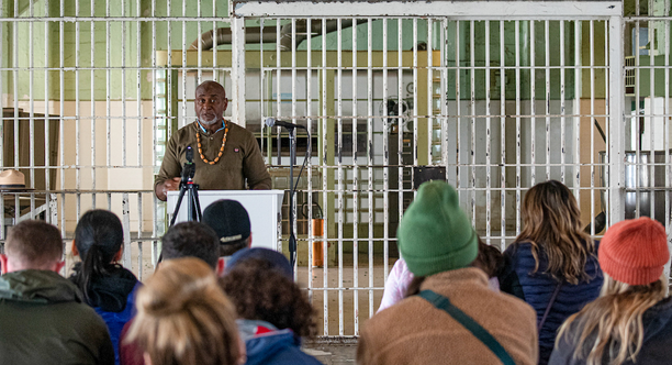 A formerly incarcerated speaker lectures in the Alcatraz Dining Hall